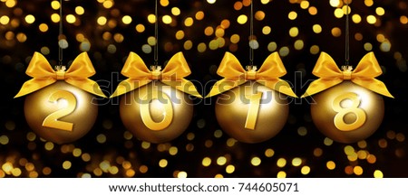 happy new year christmas balls with golden ribbon bow and text on golden blurred lights background