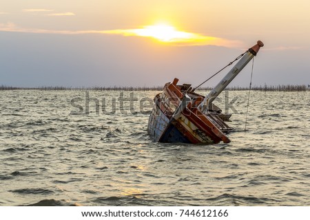 Boat crashes in the sea,Thailand. / An old shipwreck on beach. / Shipwreck in Thailand. Royalty-Free Stock Photo #744612166