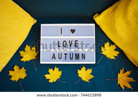 lightbox with yellow leaves on a plaid-inscription I love autumn.
