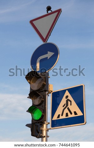 Green traffic signal, road signs