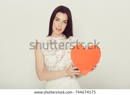 Woman with big red heart cartoon over light background.