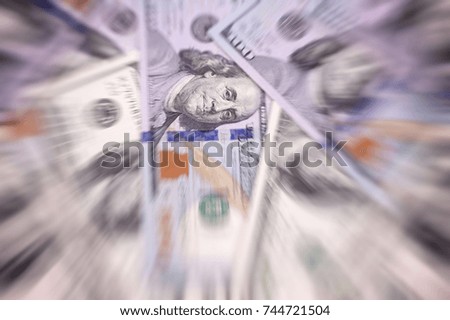 American dollar of different denominations blured background