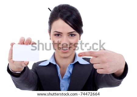 Portrait of a smiling young woman pointing at blank card in her hand against white background