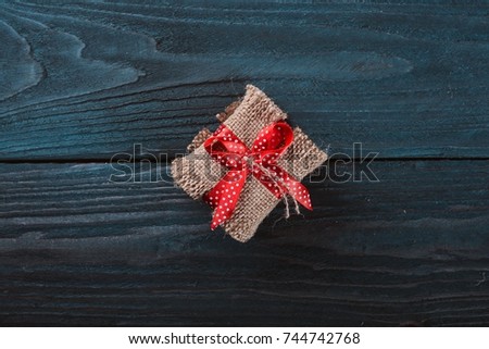 Gift. Christmas motive. On a wooden surface. Top view. Free space for your text.