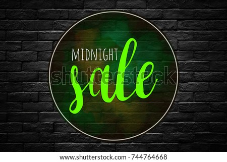 midnight sale text on black brick wall in shopping mall background.