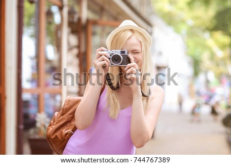 Female tourist taking photo outdoors