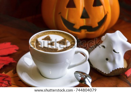 decor in a coffee house a cup of cappuccino with a picture on a theme of halloween / coffee for halloween