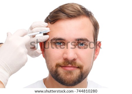 A man is injected into the forehead. Isolated over white background.
