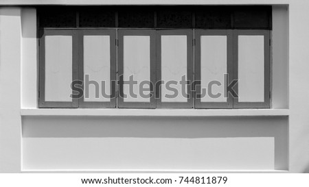 wood window at concrete building - monochrome