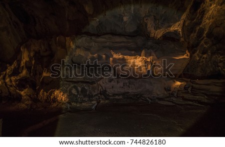 limestone cave with flashlight paing on caves wall