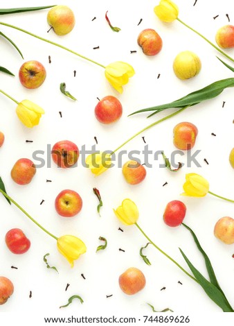 Pattern of fruits and flowers of yellow tulips. A composition of apples and flowers. Wallpaper fruits. Top view, flat lay.
