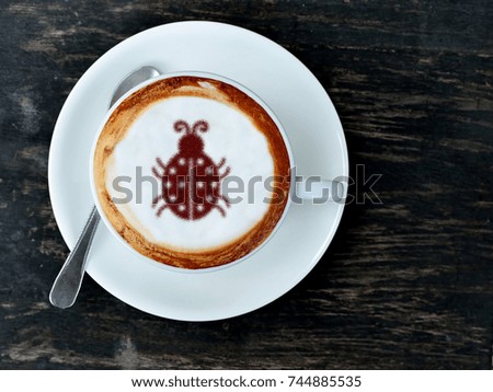 Coffee cup with bug picture on top