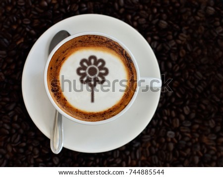 Coffee cup with flower picture on top