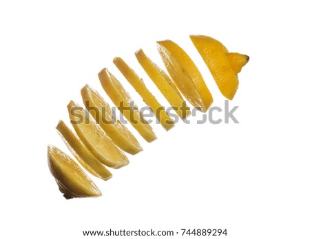 Falling slices of lemon isolated on white background
