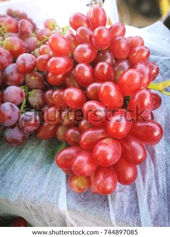 Group of red grapes ready for sale in the market.