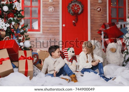 little boy and girl with gifts. happy little boy holding Christmas gift