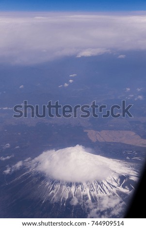 view of fuji mountain and wing of the air plane from window airplane with Aerial view background, Yamanashi, Japan