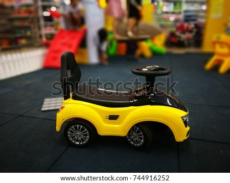 Yellow car toy at children play room.