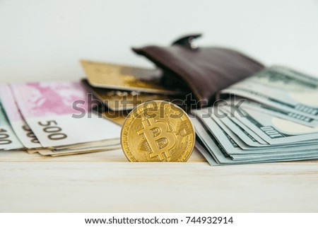 money euro dollars and bitcoin with wallet and bank cards on white wooden background