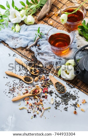 Food and drink, still life concept. Selection assortment of different japanese chinese herbal masala tea infusion beverage teapot with white flowers on the table