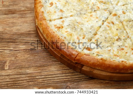sliced cheese pizza on a wooden background