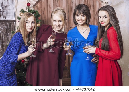 Beautiful young and happy woman girlfriends together to celebrate Christmas
