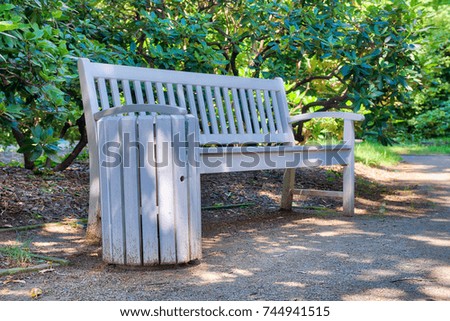 Beautiful wooden bench along a city park. Relax concept.