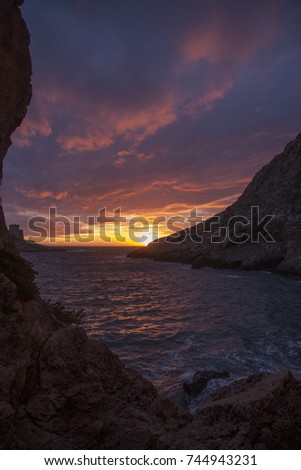 Sunset on the Mediterranean sea from Xlendi, Gozo, Malta.