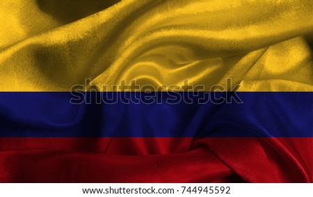 Realistic flag of Colombia on the wavy surface of fabric. This flag can be used in design.
