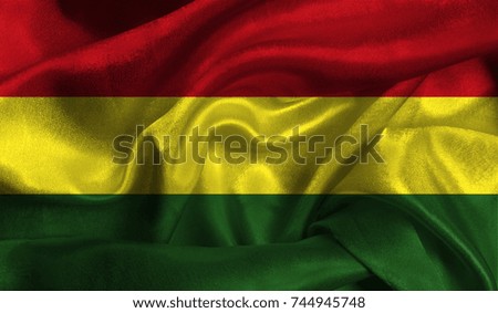 Realistic flag of Bolivia on the wavy surface of fabric. This flag can be used in design.