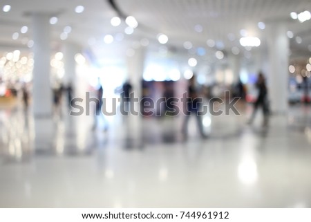 Abstract blur people in shopping mall and department store interior for background with bokeh light.