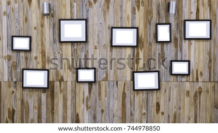 Blank photo frame on wooden wall