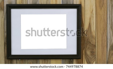 Blank photo frame on wooden wall