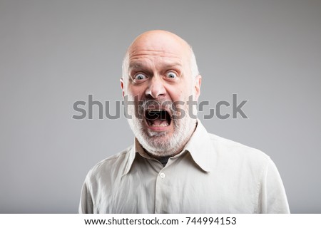 fear on the face of an old scared man - concept of elemental FEAR Royalty-Free Stock Photo #744994153