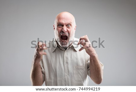 this man is growing so angry that he could get mad or transform himself into a wolf Royalty-Free Stock Photo #744994219