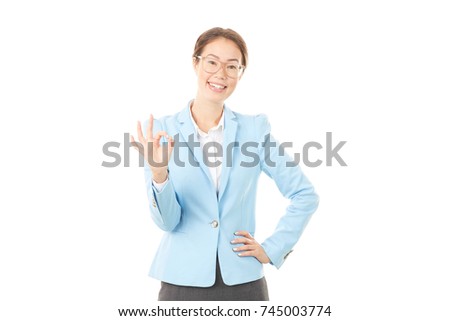 Studio portrait of Asian businesswoman in eyeglasses posing on white background