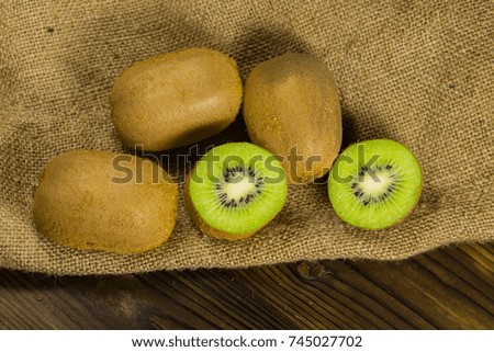 Kiwi fruit on sackcloth on wooden table