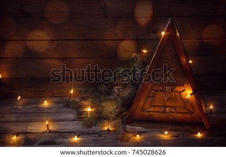 vintage clock with Christmas tree on wooden background