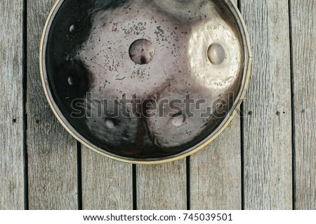 hang drum on wooden background