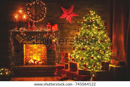 interior christmas. magic glowing tree, fireplace gifts in  dark at night
