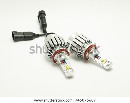 Closeup picture of two LED bulbs for car headlight on white background. Modern lighting technology.