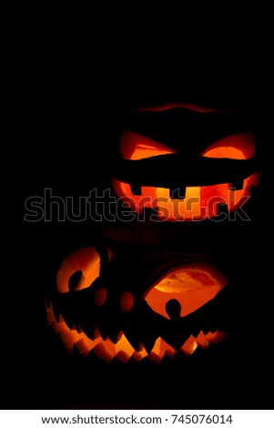 Scary Halloween pumpkins isolated on a black background.