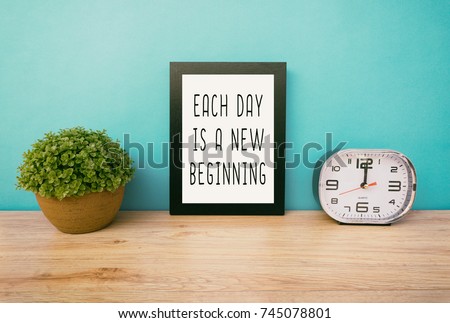 Motivational and inspirational life quotes - Each day is a new beginning. Frame and plant with teal blue background, retro style.
