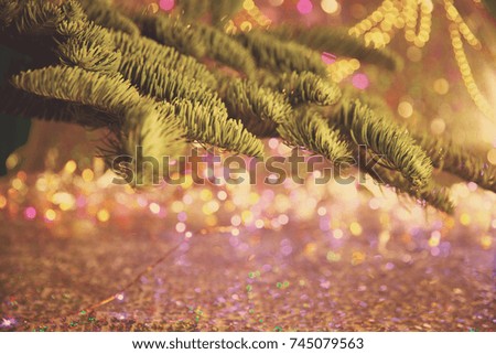 Christmas card. Background on a theme of New Year's  party. Decorated fir-tree with gifts and candles on the background of colorful festive lights. A magical evening.