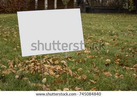 Blank lawn sign in park