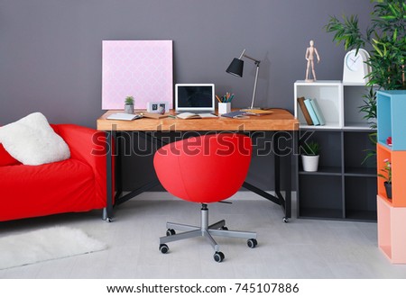 Modern room interior with laptop on wooden table