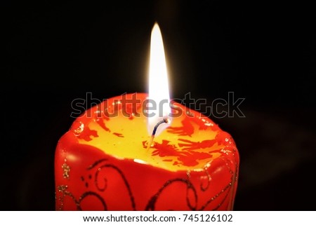 Christmas Candle. Darkness And Candlelight. Beautuful Festive Dark Background. Burning wax candles.