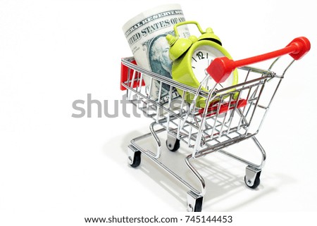 The dollars and alarm clock in the mini-shopping cart