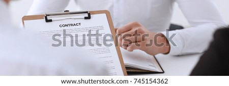 Male arm in shirt offer contract form on clipboard pad and silver pen to sign closeup. Strike a bargain for profit white collar motivation union decision corporate sale insurance agent concept