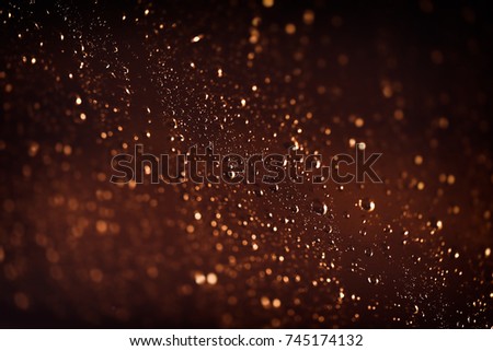 Brown background with water drops, rainy weather at night, rain drops on the window, abstract textured wallpaper, autumn season concept
